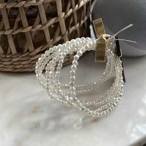 Tiny pearl-bead stretch bracelets. (Set -of-six strands)